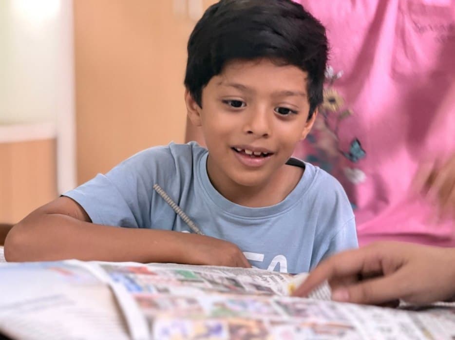 A young student reading at MGIS Jaipur